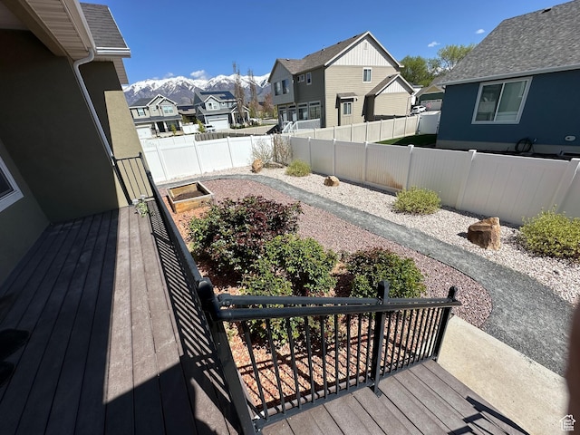 exterior space featuring a wooden deck, a fenced backyard, and a residential view