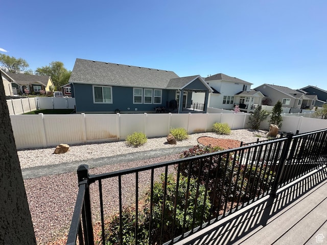 exterior space with a residential view and a fenced backyard