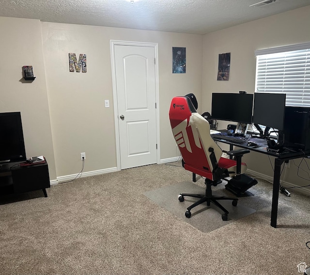 home office featuring baseboards, carpet flooring, a textured ceiling, and visible vents