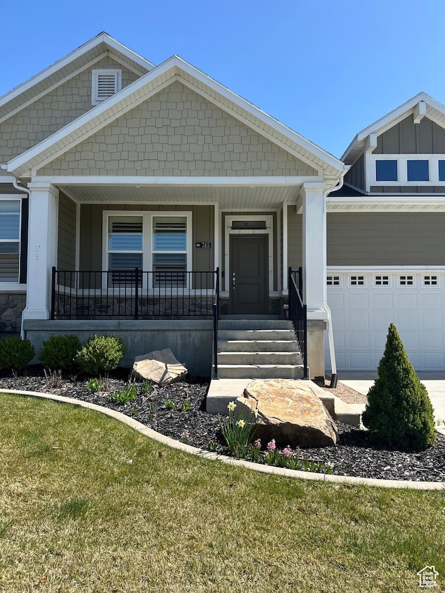 craftsman inspired home with a porch and an attached garage