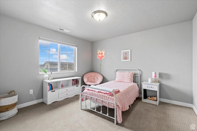bedroom with carpet floors, visible vents, and baseboards