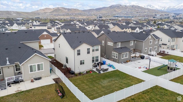 drone / aerial view featuring a residential view and a mountain view