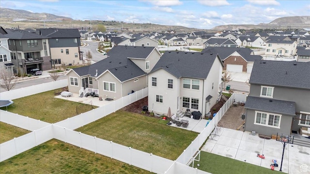 birds eye view of property with a mountain view and a residential view