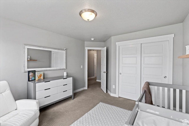 bedroom featuring baseboards, a closet, a textured ceiling, and carpet