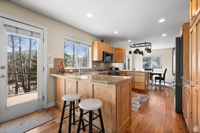1975 Picabo St, Park City, UT 84098 - kitchen with a peninsula, a sink, gas range oven, stainless steel refrigerator, and black microwave