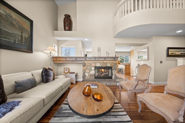 1975 Picabo St, Park City, UT 84098 - living room with a fireplace, wood finished floors, a towering ceiling, and baseboards