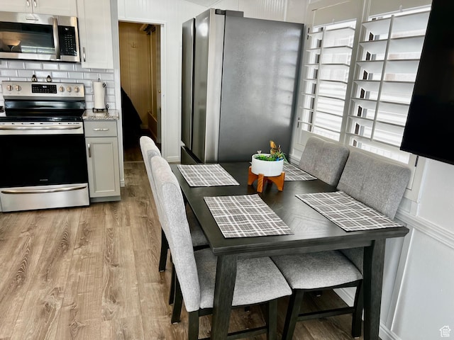 1150 W Red Hills Pkwy Unit 113, Washington, UT 84780 - dining area with light wood-style flooring