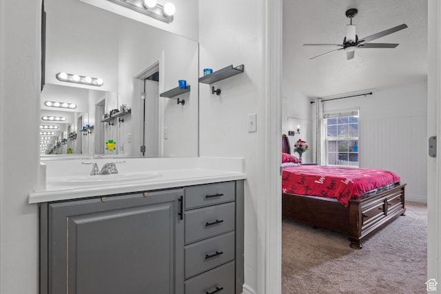 ensuite bathroom featuring ensuite bath, a ceiling fan, and vanity