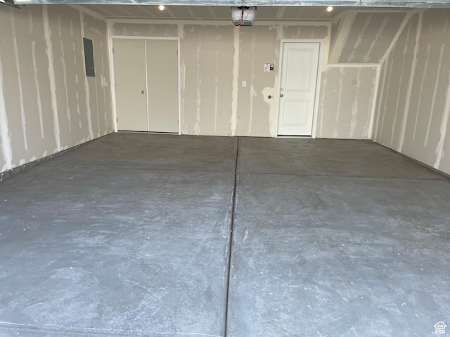 garage with a garage door opener and electric panel