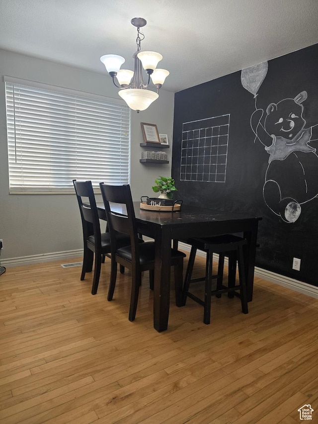 322 S 800 W, Vernal, UT 84078 - dining space featuring baseboards, a notable chandelier, visible vents, and light wood-style flooring