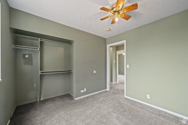 unfurnished bedroom featuring a ceiling fan, a textured ceiling, a closet, baseboards, and carpet flooring