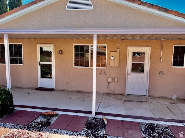 1050 W Red Hills Pkwy Unit 64, Washington, UT 84780 - view of exterior entry with stucco siding and a patio area