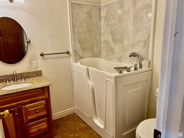 1050 W Red Hills Pkwy Unit 64, Washington, UT 84780 - bathroom featuring tile patterned floors, toilet, baseboards, vanity, and a tub