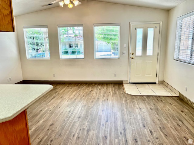 1050 W Red Hills Pkwy Unit 64, Washington, UT 84780 - unfurnished dining area with lofted ceiling, visible vents, light wood finished floors, and a healthy amount of sunlight