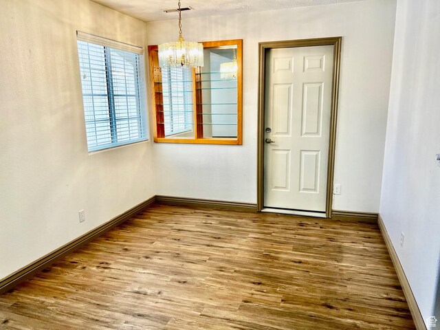 1050 W Red Hills Pkwy Unit 64, Washington, UT 84780 - unfurnished dining area featuring baseboards, wood finished floors, a chandelier, and visible vents