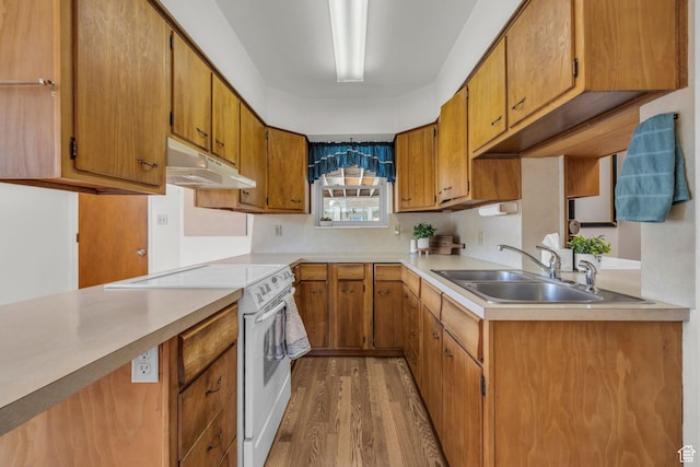311 E 100 S, Springville, UT 84663 - kitchen featuring light wood finished floors, under cabinet range hood, light countertops, a sink, and white range with electric cooktop