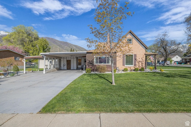 311 E 100 S, Springville, UT 84663 - view of front of house with a mountain view, a front lawn, concrete driveway, and an attached carport
