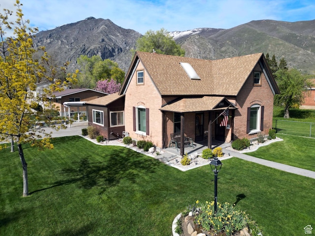 exterior space with brick siding, roof with shingles, and a mountain view