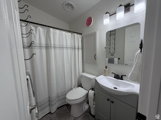 1150 W Red Hills Pkwy Unit 137, Washington, UT 84780 - bathroom featuring toilet, vaulted ceiling, a textured wall, vanity, and a shower with shower curtain