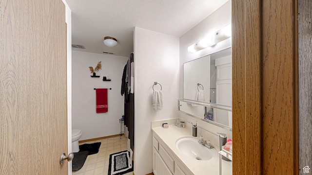 bathroom with visible vents, tile patterned floors, vanity, and toilet