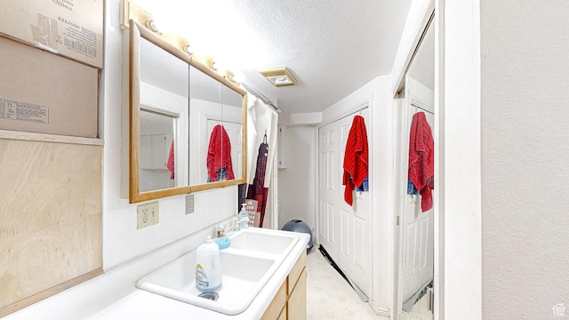 bathroom featuring vanity and a textured ceiling