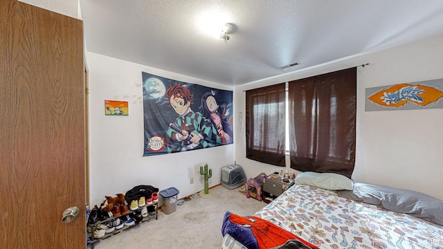 carpeted bedroom with a textured ceiling