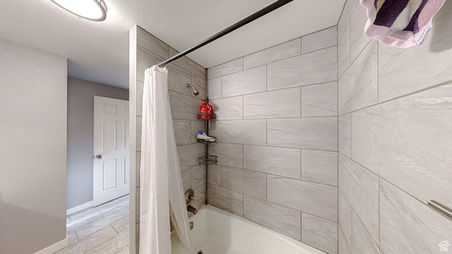 full bath with shower / bath combo and baseboards