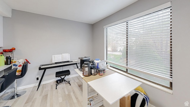 office space featuring baseboards and wood finished floors