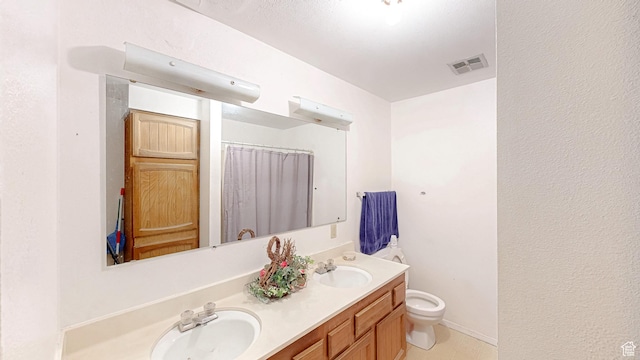 full bathroom featuring double vanity, visible vents, toilet, and a sink