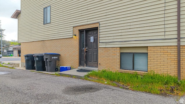 property entrance featuring brick siding