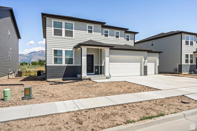 3448 S 3100 W Unit 153, West Haven, UT 84401 - prairie-style home with concrete driveway, a mountain view, and a garage