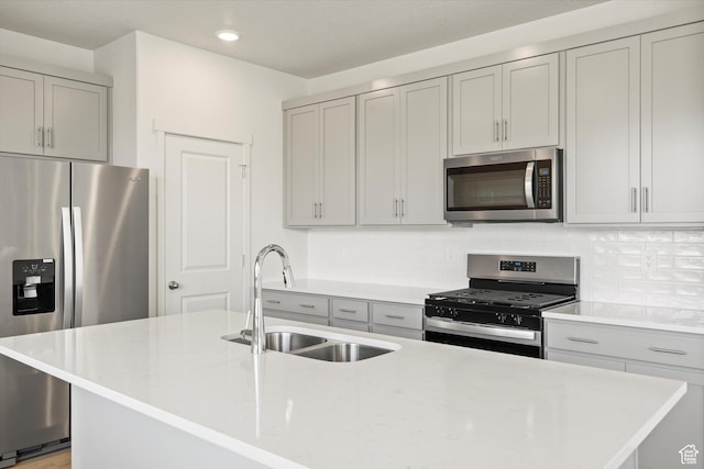 3448 S 3100 W Unit 153, West Haven, UT 84401 - kitchen with stainless steel appliances, gray cabinetry, decorative backsplash, recessed lighting, and an island with sink