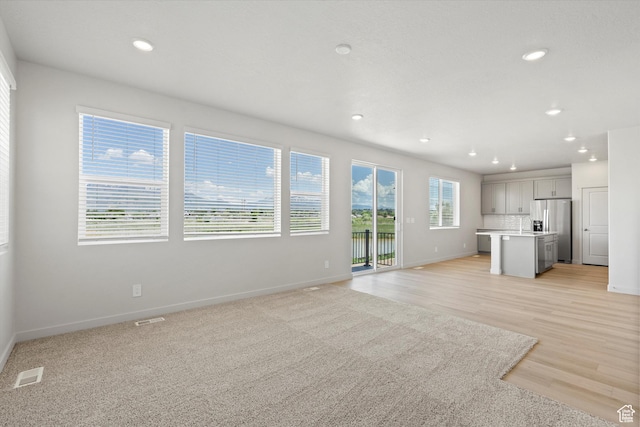 3448 S 3100 W Unit 153, West Haven, UT 84401 - unfurnished living room with recessed lighting and light wood finished floors