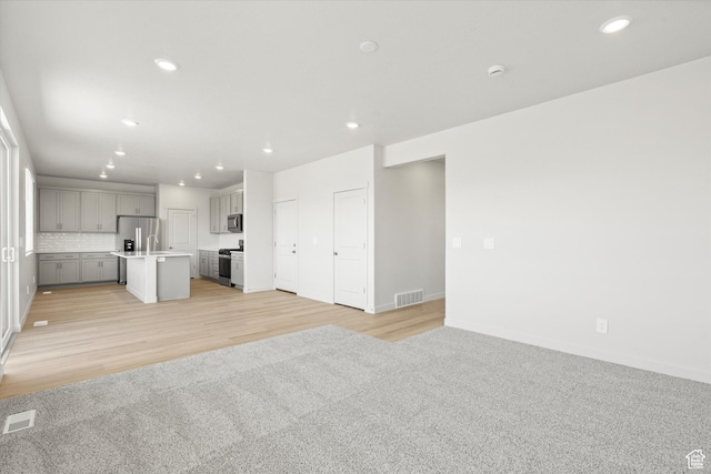3448 S 3100 W Unit 153, West Haven, UT 84401 - unfurnished living room with recessed lighting and light wood-style flooring
