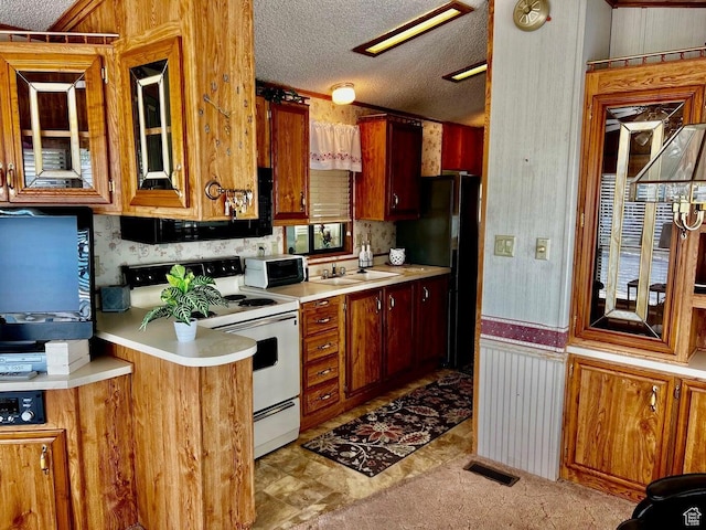 1150 W Red Hills Pkwy Unit 21, Washington, UT 84780 - kitchen featuring white range with electric stovetop, light countertops, visible vents, a sink, and a textured ceiling