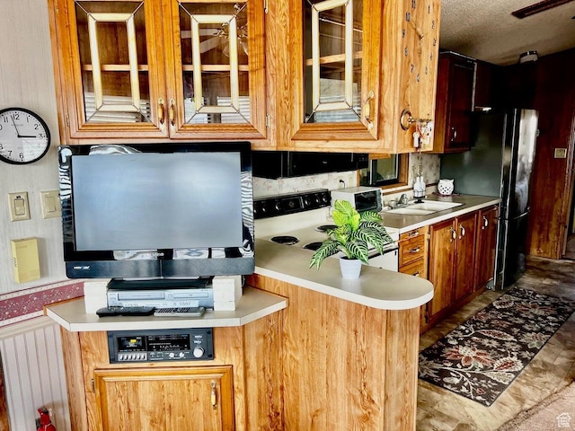 1150 W Red Hills Pkwy Unit 21, Washington, UT 84780 - kitchen with glass insert cabinets, light countertops, freestanding refrigerator, and electric stove