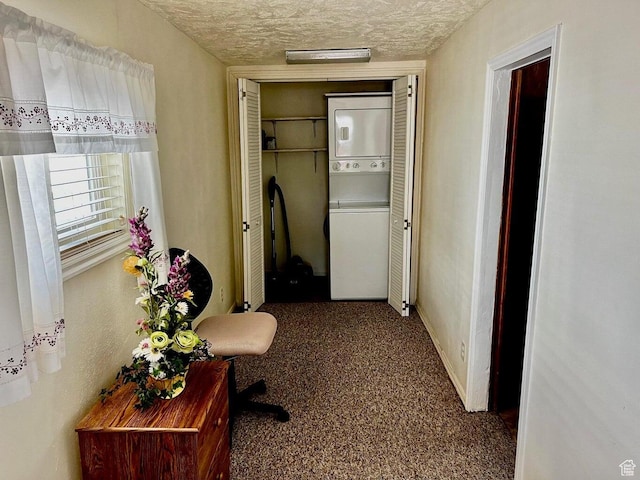 1150 W Red Hills Pkwy Unit 21, Washington, UT 84780 - corridor with stacked washer / drying machine, a textured ceiling, carpet flooring, and baseboards