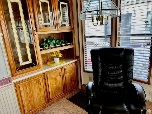 1150 W Red Hills Pkwy Unit 21, Washington, UT 84780 - bar featuring a healthy amount of sunlight, light colored carpet, and an inviting chandelier