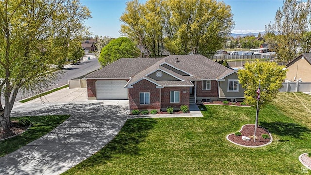 5195 S 5825 W, Hooper, UT 84315 - view of front facade featuring fence, a front lawn, concrete driveway, an attached garage, and brick siding