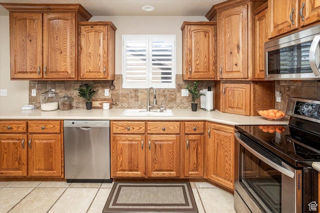 5195 S 5825 W, Hooper, UT 84315 - kitchen with decorative backsplash, brown cabinets, stainless steel appliances, and a sink