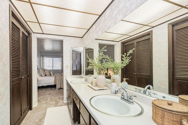 325 E 2550 N Unit 4, North Ogden, UT 84414 - ensuite bathroom with wallpapered walls, a sink, double vanity, and a closet
