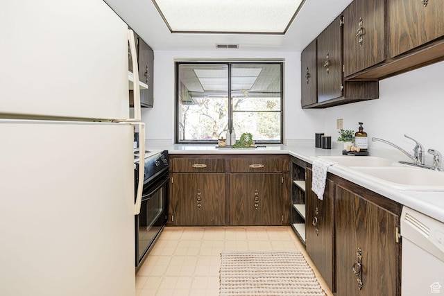 325 E 2550 N Unit 4, North Ogden, UT 84414 - kitchen with light countertops, dark brown cabinets, visible vents, a sink, and white appliances