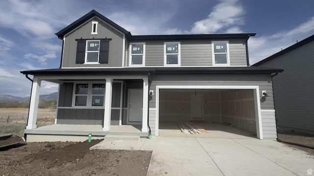 3444 S 3100 W Unit 154, West Haven, UT 84401 - view of front of house with an attached garage, driveway, board and batten siding, and a porch