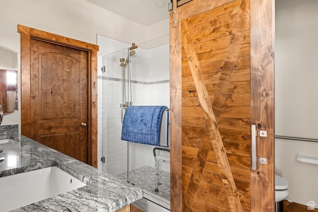1428 N Broad Hollow Rd, Garden City, UT 84028 - bathroom featuring toilet, double vanity, and a stall shower