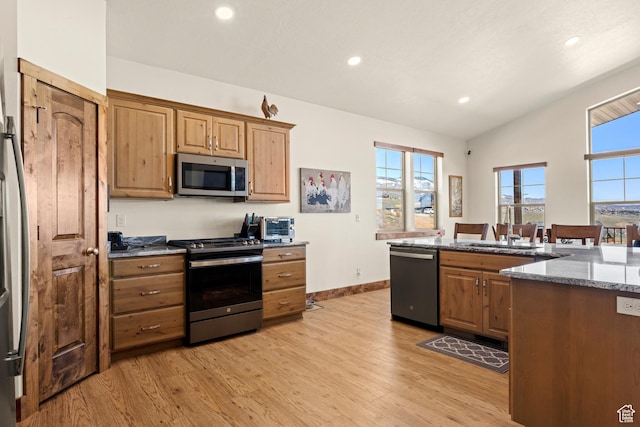 1428 N Broad Hollow Rd, Garden City, UT 84028 - kitchen featuring vaulted ceiling, stone countertops, light wood-style flooring, appliances with stainless steel finishes, and recessed lighting