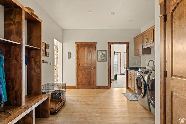 1428 N Broad Hollow Rd, Garden City, UT 84028 - clothes washing area featuring light wood-type flooring, independent washer and dryer, and cabinet space
