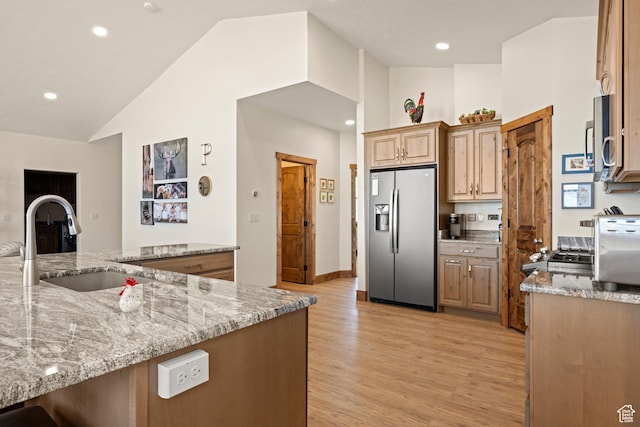 1428 N Broad Hollow Rd, Garden City, UT 84028 - kitchen featuring vaulted ceiling, a sink, light wood-style floors, light stone countertops, and appliances with stainless steel finishes