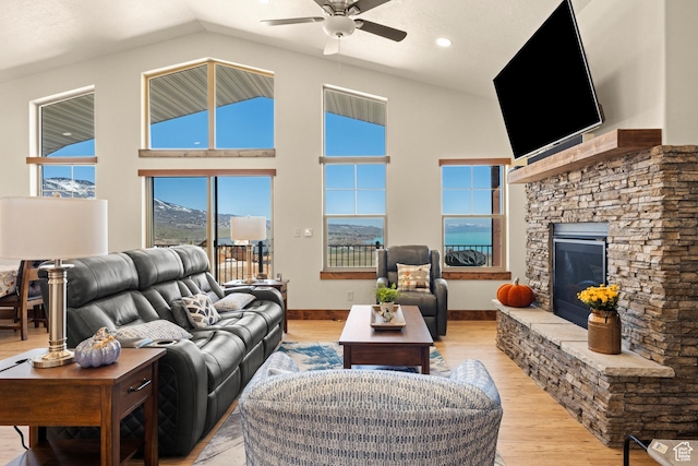 1428 N Broad Hollow Rd, Garden City, UT 84028 - living area featuring light wood finished floors, a ceiling fan, a stone fireplace, and high vaulted ceiling