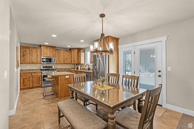 dining space with baseboards, recessed lighting, a chandelier, and light tile patterned floors