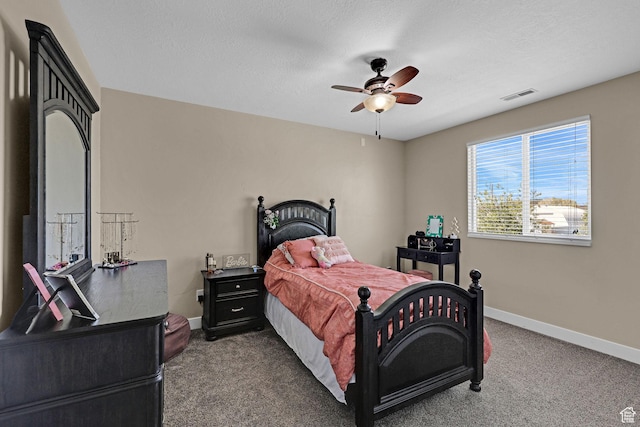 carpeted bedroom featuring baseboards, visible vents, and ceiling fan
